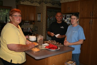 Karen Robertson, right, works with helpers Bill Hess and Sheila Johns to make poms, bite-sized cakes dipped in chocolate. Poms, Passionist Overseas Mission Sweets, sales benefit Father Rick’s mission work in Haiti.  
