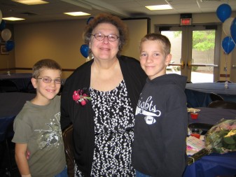 Joanne Krudop pictured with former students Michael and David Langford is shown at the Oct. 4 reception to honor the 43-year veteran first-grade teacher who retired from St. Joseph-St. Elizabeth School in Fort Wayne.