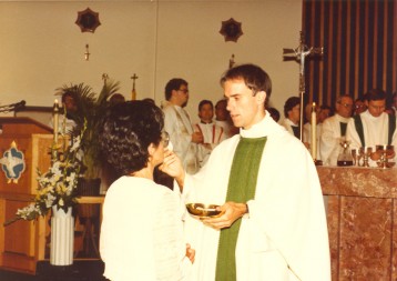 Bishop Kevin C. Rhoades, shown at his ordination to the priesthood in July of 1983, gives communion to his mother, Mary.