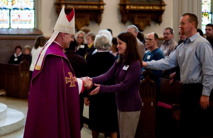Catechumens and candidates gather with bishop at cathedral