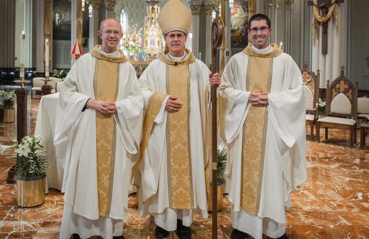 Bishop Rhoades ordains two Holy Cross priests