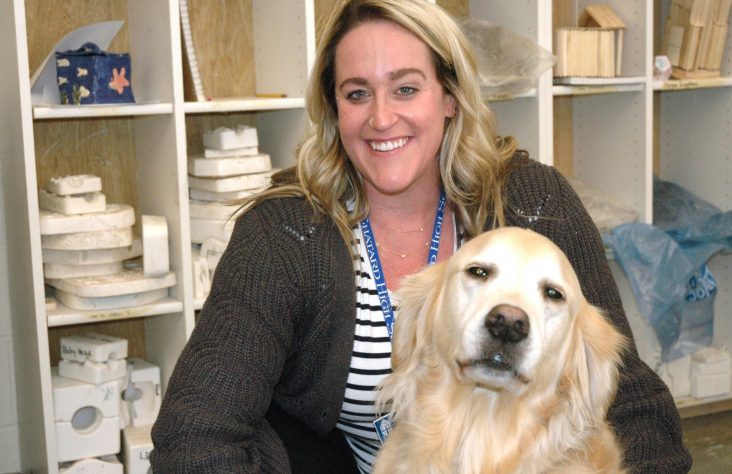 Golden retriever, her owner share joy with students 