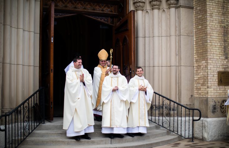 Bishop Rhoades ordains three new Holy Cross priests