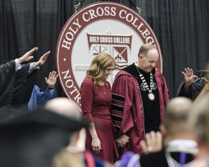 Evan Cobb Dr. Marco Clark, new Holy Cross College President, and First Lady Peggy Clark, receive a final blessing at the installation ceremony.